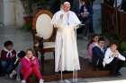 Young people sit near Pope Francis as he speaks to pilgrims during a visit to the Sanctuary of the Holy House on the feast of the Annunciation in Loreto, Italy, March 25, 2019. 