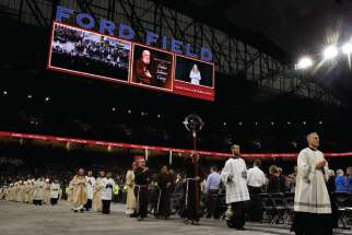 Clergymen process during the beatification Mass of Blessed Solanus Casey Nov. 18 at Ford Field in Detroit. At least 60,000 attended the beatification of the Capuchin Franciscan friar. 