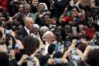 People take pictures with mobile phones and tablets as Pope Francis arrives at the Vatican on Nov. 21, 2015.