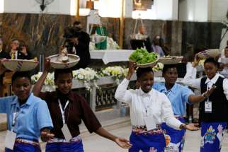 Women carry baskets of food on their heads as they dance during Pope Francis&#039; meeting with bishops, priests, religious, seminarians and catechists at the Cathedral of Our Lady of the Immaculate Conception in Maputo, Mozambique, Sept. 5, 2019.