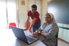 Indian Sister Veera Bara helps Pakistani migrant Gishon Payan with an Italian lesson June 4 at the classroom of the St. Pius X Catholic Church in Caltanisetta, Italy. Payan says he has no choice but to try to work in Europe to support his widowed mother and eight siblings after taking a loan of more than $10,000 to make the two-month journey by bus and foot to Italy.