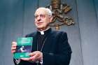 Cardinal Lorenzo Baldisseri, secretary-general of the Synod of Bishops, holds Pope Francis’ apostolic exhortation, “Christus Vivit” (Christ Lives), during a news conference April 2. 