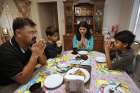 Members of the Sharif family share tea at their home in Chicago Feb. 4. They made their way to the United States from Pakistan 20 months ago after being targeted and threatened by a Muslim extremist group.