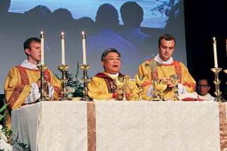Bishop Joseph Nguyen, centre, celebrates Mass after being ordained bishop of Kamloops, B.C.