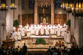 Bishop Douglas Crosby, centre, presided over the service for the Mass of Chrism at Hamilton’s Cathedral Basilica of Christ the King on April 15 to begin Holy Week. The liturgy was attended by people representing all segments of the Catholic population. 
