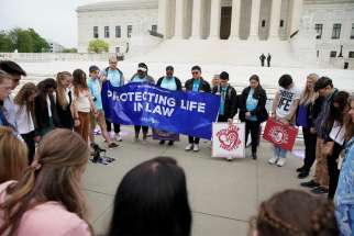 Abortion demonstrators are seen outside the U.S. Supreme Court in Washington May 3, 2022, after the leak of a draft majority opinion written by Justice Samuel Alito preparing for a majority of the court to overturn the landmark Roe v. Wade abortion rights decision later this year.