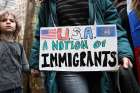 A woman holds a child&#039;s hand as they arrive for a rally in support of immigrants&#039; rights in New York City Dec. 18, 2016. &quot;We are expecting the worst,&quot; said one Catholic priest from San Jose regarding Trump&#039;s new immigration policies.