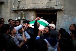 Mourners carry the body of a Palestinian man, who was killed during clashes at the Israel-Gaza border, during his April 2 funeral in Khan Younis, in the southern Gaza Strip. In his Easter appeal for peace throughout the world, Pope Francis made special mention of the ongoing &quot;carnage&quot; in Syria and the recent violence along Israel&#039;s border with the Gaza Strip. 