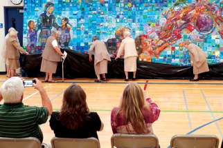 Sisters of Charity (also known as the Grey Nuns) participate in the unveiling of “The Humble Seamstress,” a mural at Edmonton’s St. Alphonse Academy honouring Sr. Marie Alphonse, the province’s first educator.