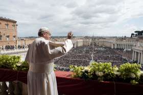 Pope Francis greets the crowd during his Easter message and blessing &quot;urbi et orbi&quot; (to the city and the world) delivered from the central balcony of St. Peter&#039;s Basilica at the Vatican April 1. 