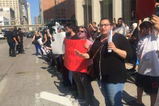 Protesters in front of the McNamara Federal Building in Detroit chant “Stop deportations, bring our families home” on June 14, 2017.
