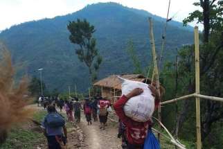 People in northwestern Myanmar displaced by fighting walk in Chin state May 31, 2021. Thousands of people have taken refuge in churches and convents as Myanmar&#039;s military continues to fight local resistance forces.