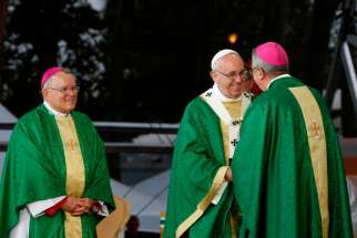 Pope Francis greets Dublin Archbishop Diarmuid Martin during the closing Mass of the World Meeting of Families on Benjamin Franklin Parkway in Philadelphia Sept. 27. The 2108 World Meeting of Families is to be held in Dublin. Looking on is Archbishop Charles J. Chaput of Philadelphia. 