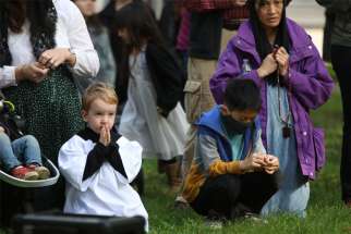 Maxxis Brehm, 4, prays for peace and justice during a rosary led by Archbishop Alexander K. Sample of Portland, Ore., Oct. 17, 2020.
