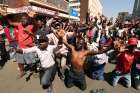  Supporters of the Movement for Democratic Change opposition party of Nelson Chamisa demonstrate outside the party&#039;s headquarters as they await the results of the general elections Aug. 1 in Harare, Zimbabwe.