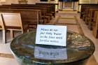 An empty holy water font at the John Paul II Pastoral Centre in Vancouver. Parishes in the Archdiocese of Vancouver have begun cancelling events in response to the coronavirus outbreak.