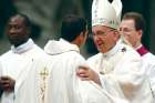 Pope Francis greets a new priest during a 2015 ordination Mass at the Vatican.