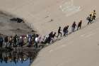 Part of a caravan of Central American migrants trying to reach the U.S. make their way to the border fence between Mexico and the United States Nov. 25 in Tijuana, Mexico.