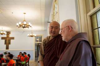 Venerable Sagarananda Tien and Father James Gardiner, a Franciscan Friar of the Atonement, talk as children from the U.S. Zen Institute summer camp eat lunch July 12 at the Franciscan Monastery of the Holy Land in Washington. The Buddhist children spent the afternoon learning about Christianity, St. Francis and the Franciscans as way to understand other traditions and cultures, said Tien.