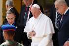 Pope Francis walks with Egyptian Prime Minister Prime Minister Sherif Ismail, right, as he arrives at the international airport in Cairo April 28.