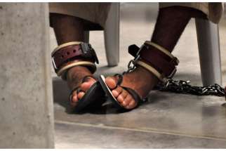 In this photo, reviewed by a U.S. Department of Defense official, a detainee&#039;s feet are shackled to the floor as he attends a &quot;Life Skills&quot; class inside Camp 6 detention center at the Guantanamo Bay Naval Base in Cuba April 27, 2010.