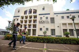 Workers walk past a building of the Jesuit-run Central American University in Managua, Nicaragua, Aug. 16, 2023. The university suspended operations Aug. 16 after Nicaraguan authorities branded the school a &quot;center of terrorism&quot; the previous day and froze its assets for confiscation.