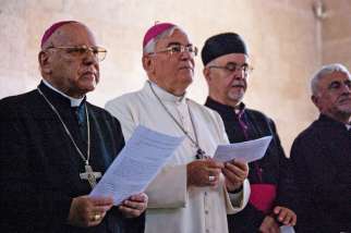 Retired Latin Patriarch Michel Sabbah of Jerusalem, Auxiliary Bishop Giacinto-Boulos Marcuzzo of Jerusalem, Maronite Catholic Bishop Moussa El-Hage of Haifa and the Holy Land and Father Bishara Suleiman gather during a prayer service at the Benedictine C hurch of the Multiplication in Tabgha, Israel June 21. Arsonists attacked the church June 18, lighting several fires that caused significant damage to the roof and two rooms, but the church, with its 5th-century mosaic floor, survived. 