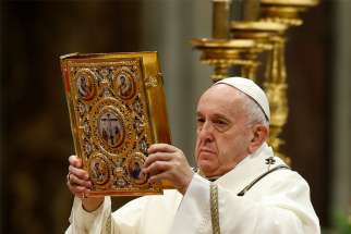 Pope Francis raises the Book of the Gospels as he celebrates Mass marking the feast of the Epiphany in St. Peter&#039;s Basilica at the Vatican Jan. 6, 2020.
