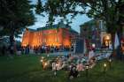 Kamloops residents and First Nations people gather to listen to drummers and singers at a memorial in front of the former Kamloops Indian Residential School on May 31.