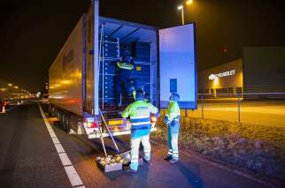 Dutch police search a Spanish truck at the border after nine immigrants were rescued from the freezer of the vehicle in early February in Hazeldonk, Netherlands. The truck driver was arrested as a suspect of human trafficking.