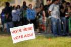 A sign in English and Spanish is seen as people wait to vote in 2012 outside a polling place in Kissimmee, Fla. A Pew Research Center poll released Oct. 10 shows Hispanic Americans give nearly a 5-1 edge to Democrats over Republicans as the party they feel is more concerned for them.