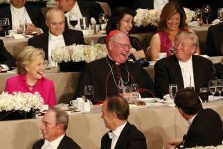 New York Cardinal Timothy M. Dolan shares a light moment with U.S. Democratic presidential nominee Hillary Clinton and Republican presidential nominee Donald Trump during the 71st annual Alfred E. Smith Memorial Foundation Dinner at the Waldorf Astoria hotel in New York City Oct. 20. 