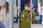 A nurse speaks with patients at the door of a new COVID-19 clinic opening at Mount Barker Hospital in Adelaide, Australia, March 17, 2020.