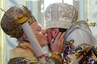  Ecumenical Patriarch Bartholomew of Constantinople kisses Metropolitan Epiphanius, head of the Orthodox Church of Ukraine, Jan. 6, as he hands him a decree granting the Orthodox Church of Ukraine independence, at the Patriarchal Cathedral of St. George in Istanbul, Turkey.