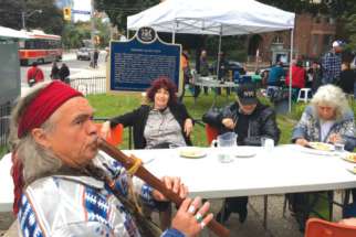 A visitor to the “pop-up” restaurant in downtown Toronto adds some flute music to the festivities. 