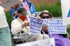 Eric and Anne Waxman recite the rosary while participating in a roadside prayer rally marking Religious Freedom Week at St. James Church in Setauket, N.Y., June 24, 2020.