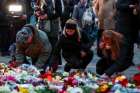 People lay candles and tributes Dec. 21, 2024, at the site where a car drove into a crowd at a Magdeburg Christmas market in Magdeburg, Germany. Germans mourned the death of at least five people, including a 9-year-old, who were killed, and hundreds others who were injured after a Saudi doctor intentionally drove into the busy Christmas market the previous day.