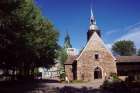 The Old Chapel housing the miraculous statue of Our Lady of the Cape was built with small stones in 1720. Behind it looms the newer basilica that seats 1,600 people.