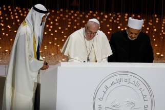 Sheik Mohammed bin Zayed Al Nahyan, crown prince of United Arab Emirates, Pope Francis and Sheik Ahmad el-Tayeb, grand imam of Egypt&#039;s al-Azhar mosque and university, sign documents during an interreligious meeting at the Founder&#039;s Memorial in Abu Dhabi, United Arab Emirates, Feb. 4, 2019. 