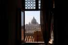 The dome of St. Peter&#039;s Basilica at the Vatican is seen through a window of Castel Sant&#039;Angelo in Rome.