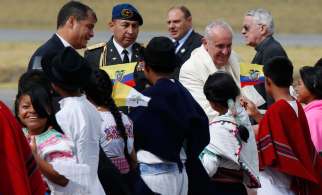 Pope Francis greets children in traditional dress as he arrives at Mariscal Sucre International Airport in Quito, Ecuador, July 5. Also pictured is Ecuadorean President Rafael Correa, left. The Pope is making an eight-day trip to Ecuador, Bolivia and Paraguay.