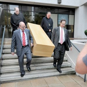 A casket is carried down the steps of the federal courthouse in New Orleans in this 2010 file photo. The monks lost a lawsuit which challenged a Louisiana law that allows only funeral home operators to sell caskets to the public.