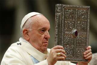 Pope Francis holds the Book of the Gospels as he celebrates Mass on the feast of Mary, Mother of God, in St. Peter&#039;s Basilica at the Vatican Jan. 1, 2020. The pope has established the third Sunday in Ordinary Time as &quot;Sunday of the Word of God.&quot; It will be celebrated for the first time Jan. 26.